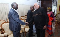 Rawlings greets Kufuor at a function.
