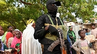A Nigerien police officer stands guard at a market