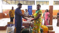 CEO of CBOD, Senyo Hosi presenting a cheque to the Headmistress of the school Mrs. Veronica Sackey