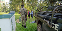 Police and forensic expats remove a body from the Gulf course grounds on June 11, 2024.