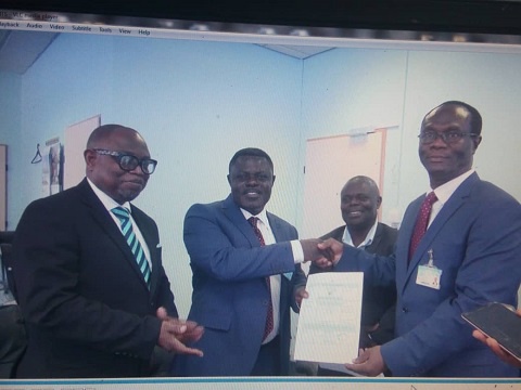 Dr Kwame Kyei (L) receiving the certificate from Mr Alottey. With them is Mr Donkor