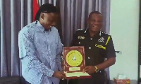 Stonebwoy  (L) receiving the honourary badge