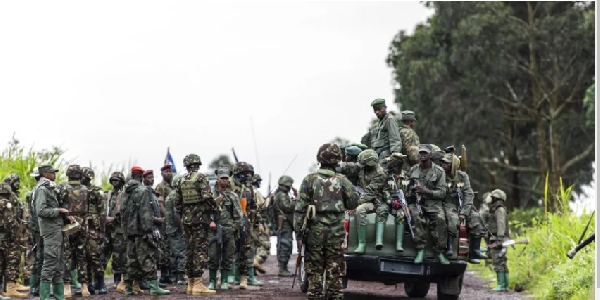 M23 rebels ride in the back of a vehicle in the town of Kibumba, eastern DRC