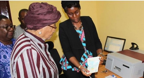President Sirleaf receiving a copy of the new passport