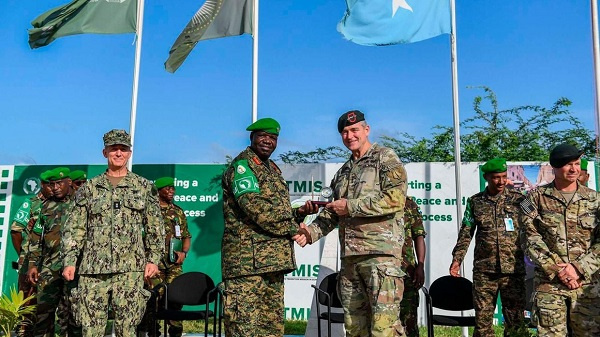 Atmis men Lt. Gen. Sam Okiding shakes hands with Rear Admiral Jamie Sands