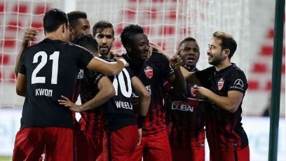 Asamoah Gyan celebrating with his Al Ahli teammates