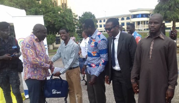 Executive Director of GIFEC, Mr. Kofi Asante donating the laptops