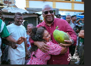 President of Ghana, John Dramani Mahama happily hugging a woman