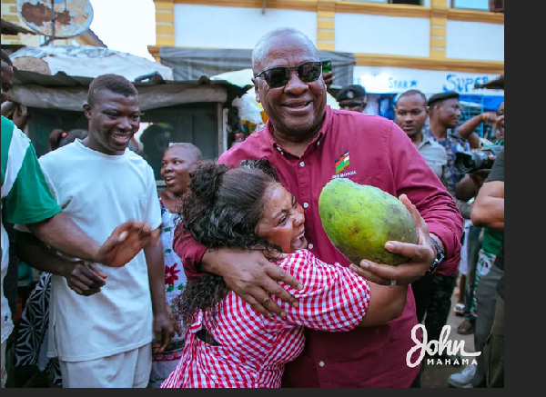 President of Ghana, John Dramani Mahama happily hugging a woman