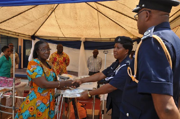 Mrs Amissah-Arthur handing over items to authorities of Police Experimental Basic School and clinic.