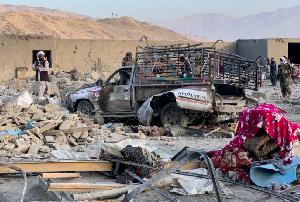 Afghan men search for victims after a Pakistani air strike hit an area in the Girdi Kas village