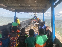 A photo of some children in a canoe on the Volta lake
