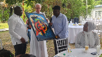 Dr. Bawumia receiving a gift from Father Andrews Campbell