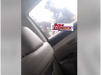 A police officer caught on video demanding 2 cedi from a driver.