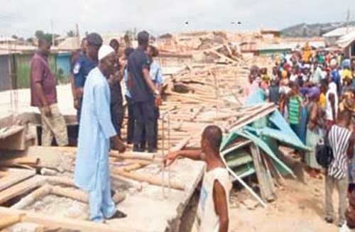 Security personnel at the site of the broken down building