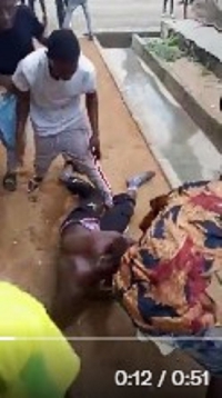 One of the supposed community policemen being attacked by the gang