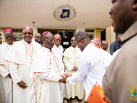 The minister in a photograph with the Bishops of the Catholic Church in Ghana