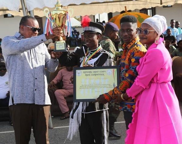 Deputy defence minister, Brogya Gyemfi presenting the Champion Band Award to OLP Girls SHS