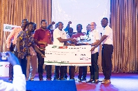 The company reps receiving their prize