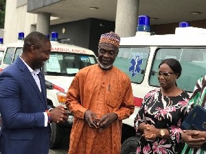 Dr. Bernard Okoe Boye (Left) presenting the ambulance to the Northern Regional Minister (Middle)