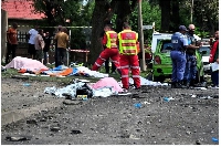 Bodies lay covered at the scene where a gas tanker exploded