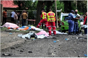 Bodies lay covered at the scene where a gas tanker exploded