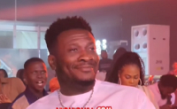 Asamoah Gyan beaming with smiles while watching Stonebwoy perform at an event