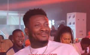 Asamoah Gyan beaming with smiles while watching Stonebwoy perform at an event