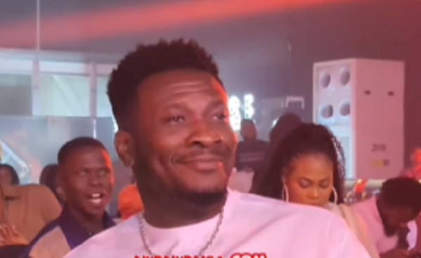 Asamoah Gyan beaming with smiles while watching Stonebwoy perform at an event