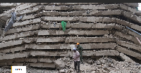 Security personnel work at the scene after a multi-storey building collapsed in Nairobi