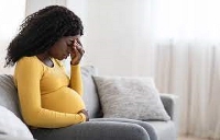 A pregnant woman looks worried