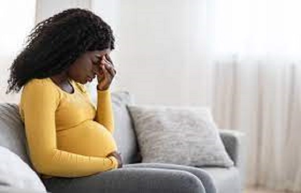 A pregnant woman looks worried