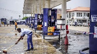 An employee cleans a petrol station in Lagos, Nigeria, (PHOTO | FILE | NMG)