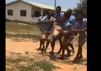 Some students carrying Edward Sackey to the hospital before he was pronounced dead