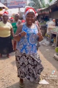 Some of the market women dancing with smiles on their faces
