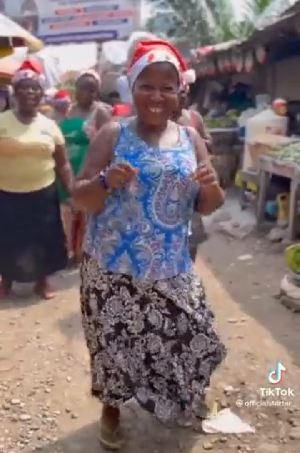 Some of the market women dancing with smiles on their faces