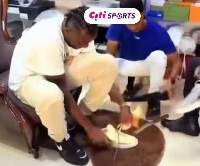 Asare (L) trying on some sneakers at the shop