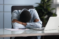 File photo of a stressed man with his head bowed