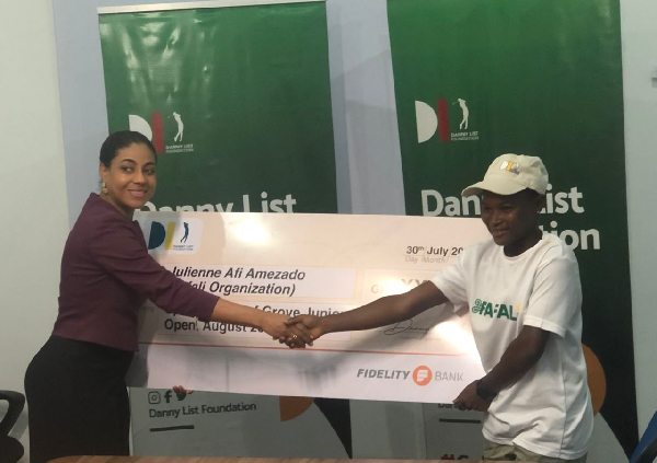 Daniel List's mother presents cheque to Afi Amezado (right)