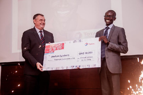 Joshua Ayinbora of JE&F Company receiving his prize