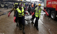 NADMO officials convey remains of victims from disaster site. File photo