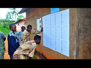 Voters look for their name on voter registration lists outside a polling station