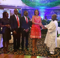Hannah Agbozo, Legal & Corporate Affairs Director- Airtel Ghana (4th from left) receiving the plaque