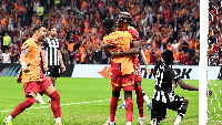 Galatasaray players celebrating their goal while Baba Rahman (number 21) watch on