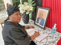 Nana Yaa Jantuah, on behalf of PURC, signs book of condolences for late Prof. Akabzaa