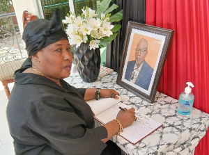 Nana Yaa Jantuah, on behalf of PURC, signs book of condolences for late Prof. Akabzaa