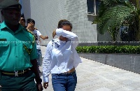 Aisha Huang being led out of court with other suspects
