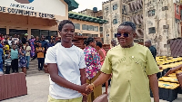 A picture of Richmond Edem Kofi Kpotosu standing with one of the student