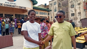 A picture of Richmond Edem Kofi Kpotosu standing with one of the student