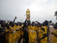 Players of Young Sharks lift the giant trophy